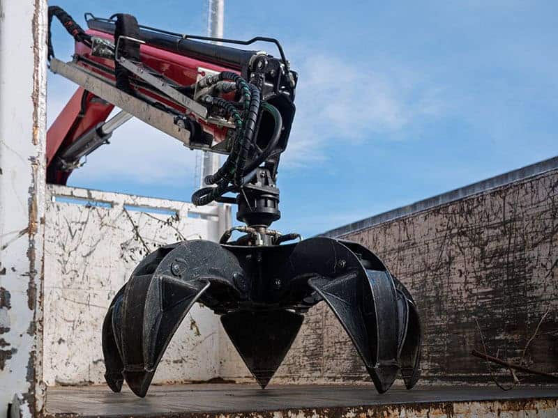 Industrial hydraulic grapple claw attachment inside truck contai