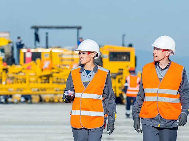 two engineers at airport runway two workers blue sky airport runway plan
