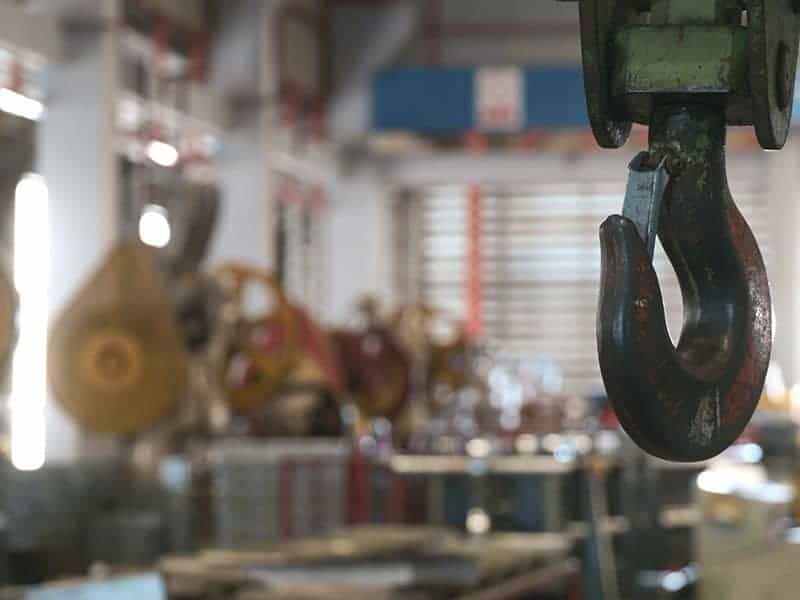 Closeup of swivel chain hook crane of electric hoist in factory workshop Closeup of swivel chain hook crane of electric hoist in factory workshop, pullersSwivel chain hook equipment for pullers, industry lifting machine