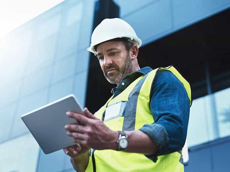 This software help me to keep track of everything. Shot of a engineer using a digital tablet on a construction site. Shot of a engineer using a digital tablet on a construction site